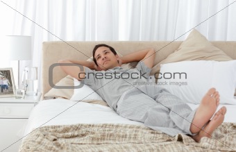 Tranquil man lying on his bed 