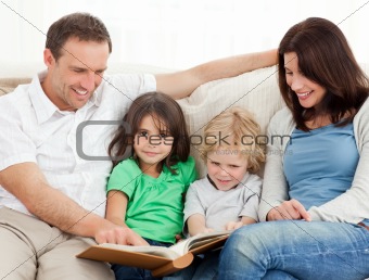 Cute girl and her family looking at a photo album