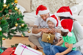 Family unwrapping gifts