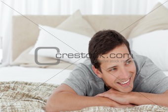 Cheerful man lying in his bedroom