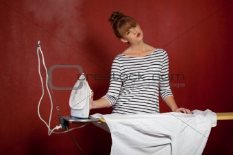 young woman ironing a shirt