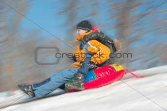  Young Boys Sledding Downhill Together