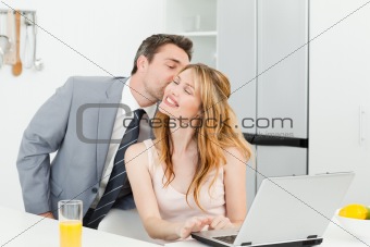Businessman kissing his girlfriend 