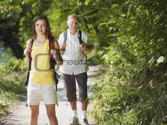 grandfather and grandaughter hiking in wood