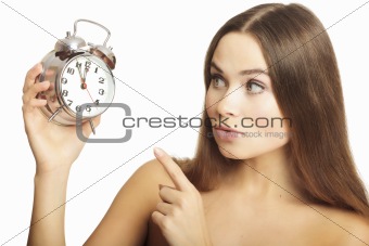 Portrait of the girl showing a finger on an alarm clock