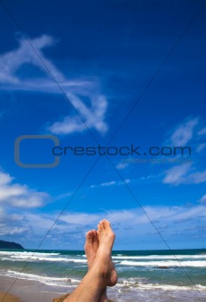 Lying on the beach with dollar symbol cloud