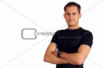 Confident young man in a fitness T-shirt with his arms crossed