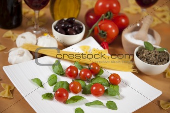 Basil and cherry tomatoes on a plate
