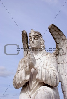 sculpture of white angel praying