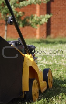 yellow lawn mower on green grass