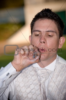 well dressed groom blowing bubbles through a wedding ring