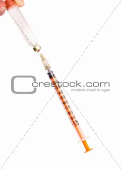 Syringe for insulin with a needle piercing a stopper of a bottle with insulin