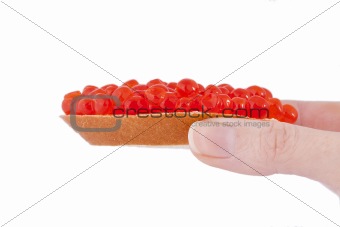 Bread and red caviar in the hend