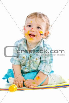 Beautiful baby covered in bright paint