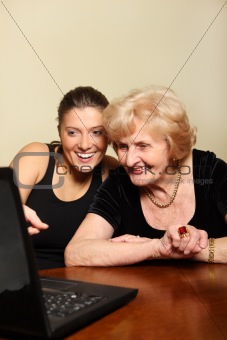 Grandma and granddaughter with a laptop