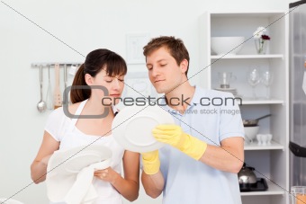Lovers washing dishes together