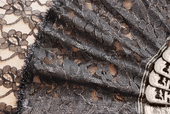 Black fan on a background a lace