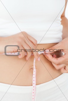 Woman looking at  her waistline
