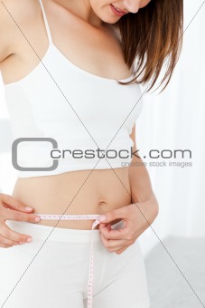 Woman looking at  her waistline