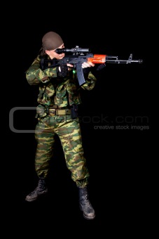 Full length shot of soldier with weapon 