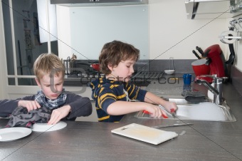 Two boys doing the dishes