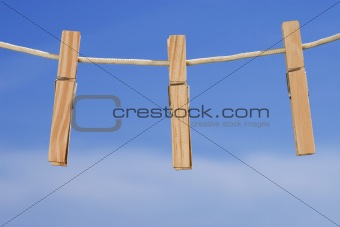 clothesline and pegs on blue sky background