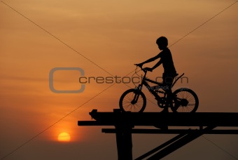 A boy sitting on bicycle