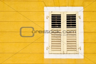 Yellow wall an and wooden window