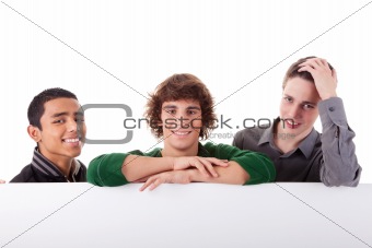 happy three young, of different colors man with a white board, isolated on a white background