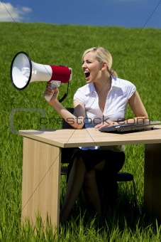 Business Concept Woman Using Megaphone In A Green Field