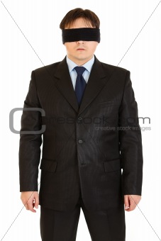 Disoriented businessman with blindfold on eyes
