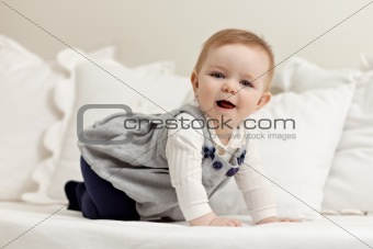 little girl walking all fours on bed