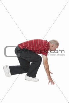 Senior man performing squat exercise