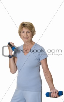 Active senior woman exercising with hand weights