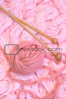 Sphere of pink wool with needles