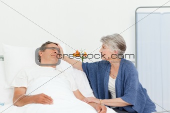 Mature woman taking care of her husband
