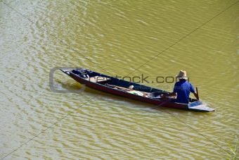 Fisherman rowing on the river