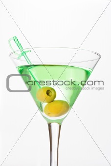 Green alcohol cocktail with martini and olives