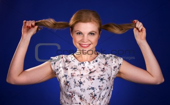 Beautiful red head woman holding her ponytails