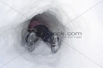 Child digging snow tunnel