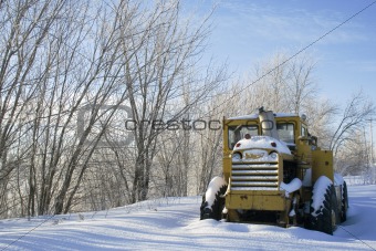 Snow covered tractor with space