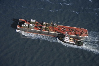 Tugboat pushing ship.