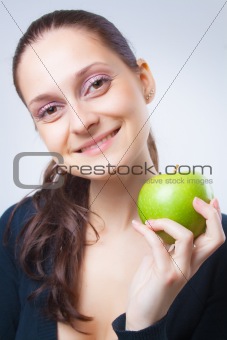 beautiful young woman holding an apple