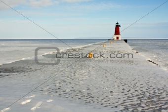 lighthouse on frozen pier