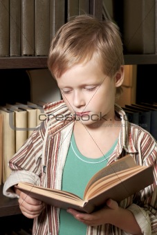 The boy reads the book.