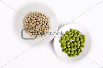 Fresh and dried green peas on plate