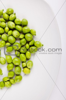 Fresh green peas on plate