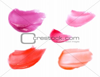 Smudged lip gloss samples isolated on white