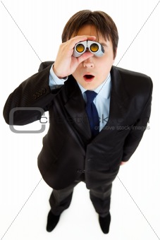 Shocked young businessman looking through binoculars
