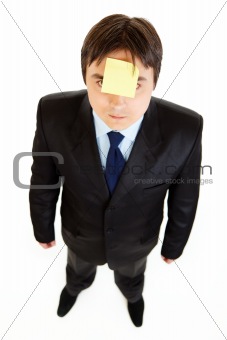 Young businessman with blank  sticky note on his forehead
